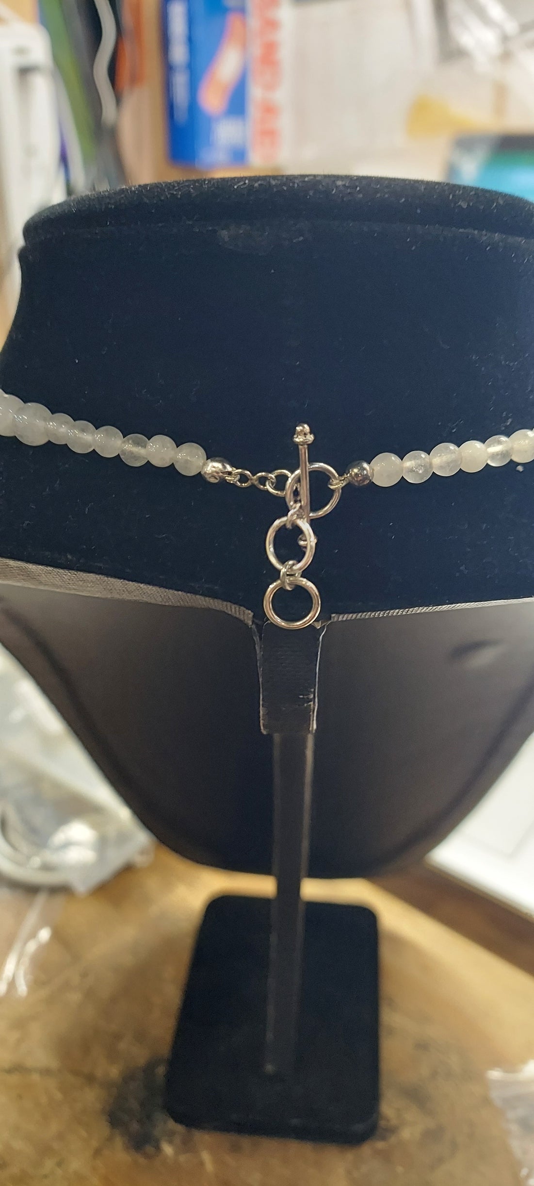 Necklace with a blue velvet stand and blurred background